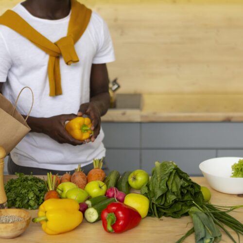 front-view-man-cooking-with-smartphone-min